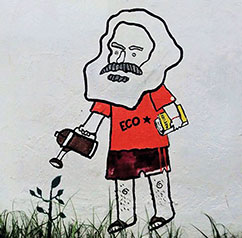 Graffiti auf dem Gelnde der Universidad Nacional in Bogot: Karl Marx giet das zarte Pflnzchen der gerechten Gesellschaft