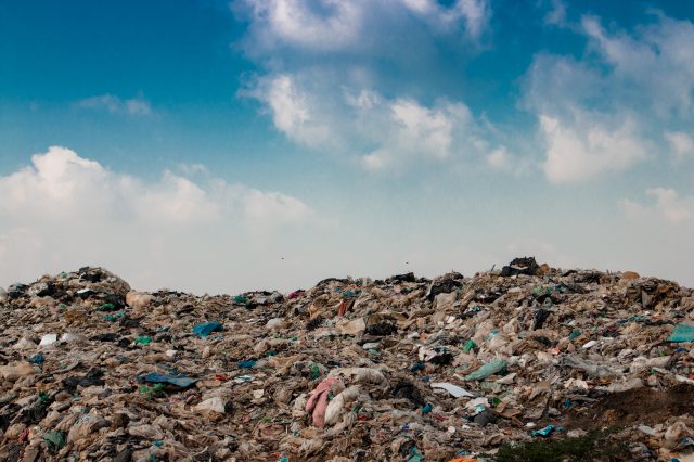 big garbage mountain with blue sky background