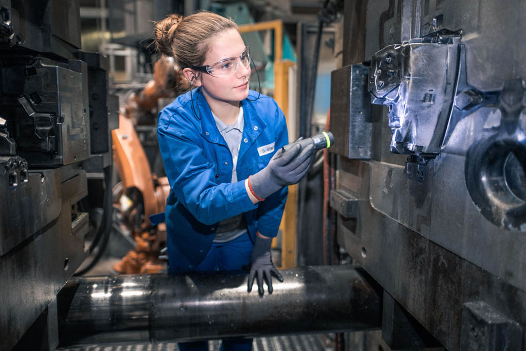 Eine Arbeiterinnen an einer Maschine bei TCG Unitech GmbH. Symbolbild: KV-verhandlungen der Metaller und Vorstandsgehälter.Metaller Lohn.