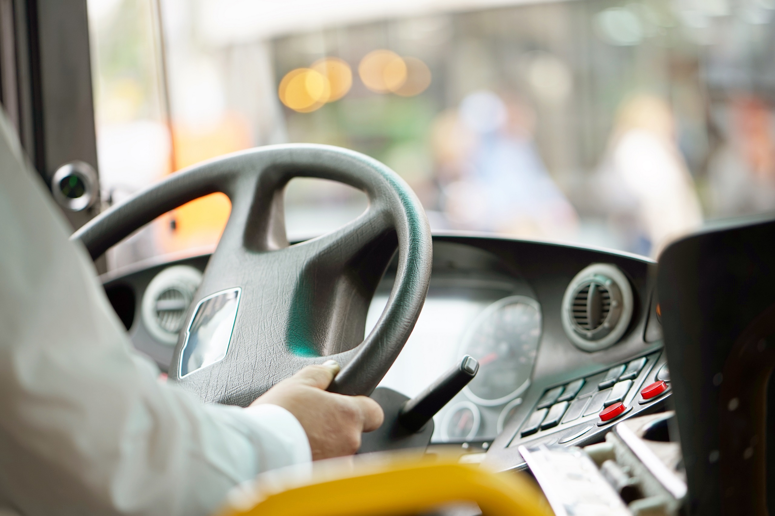 Jemand sitzt an einem Buslenkrad. Vor ihm:ihr ist der Straßenverkehr zu sehen. Symbolbild für die MVG.