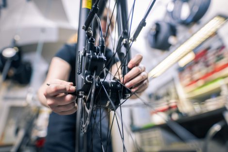 Sarah Sutlovic arbeitet an einer Fahrradkette. Symbolbild für den Lehrberuf Fahrradmechatroniker:in.